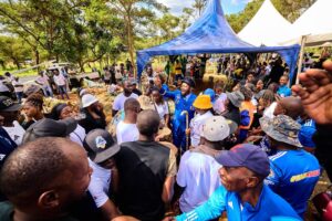 Community members and football fans attending the funeral of Evelyn Kujinga, showing support and solidarity.