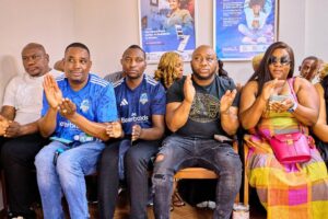 Scottland FC management standing in tribute at Evelyn Kujinga’s funeral 