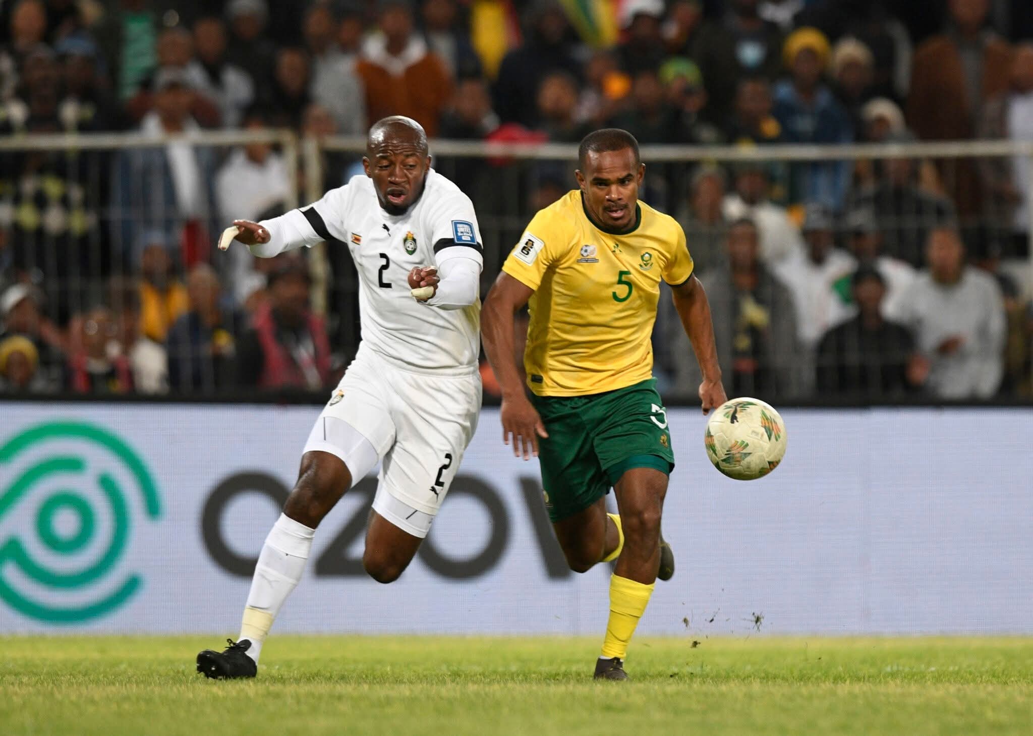 Bafana Bafana striker Iqraam Rayners challenges Zimbabwe Warriors defender Gerald Takwara during a fifa World Cup qualifiers.